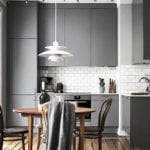 02-a-small-grey-kitchen-with-a-wooden-floor-and-a-subway-tile-backsplash-looks-interesting-though-its-small