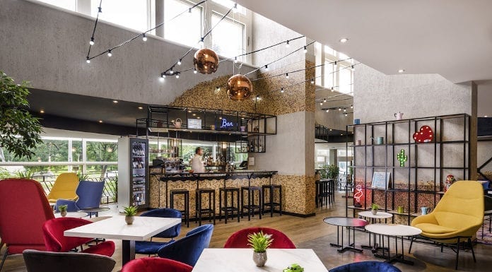 Nowoczesny hotel w Budapeszcie – czym zaskoczyli polscy architekci? nowoczesny hotel w budapeszcze mercure czerwone krzesło granatowe krzesło velur